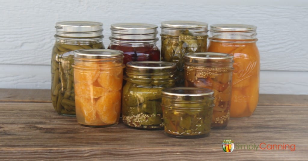 Filled canning jars in various sizes filled with different types of food.