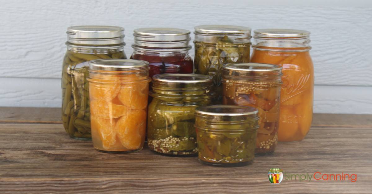 Filled canning jars in various sizes filled with different types of food.