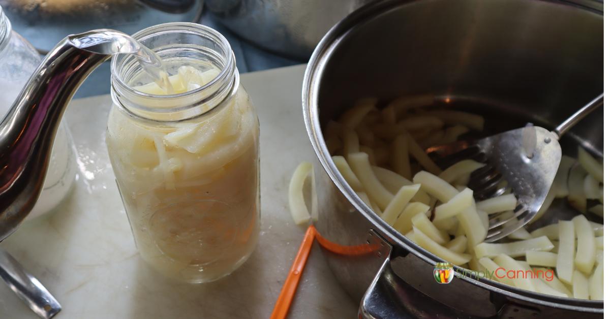 Image of filling jar of french fry cut potatoes with boiling water from a tea kettle.