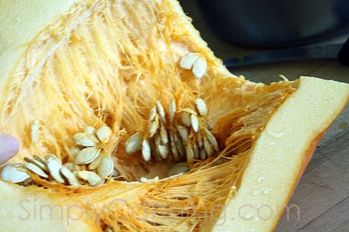 Inside of a pumpkin with seeds and pulp.