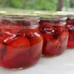 Finished jars of strawberries showing a small amount of floating.