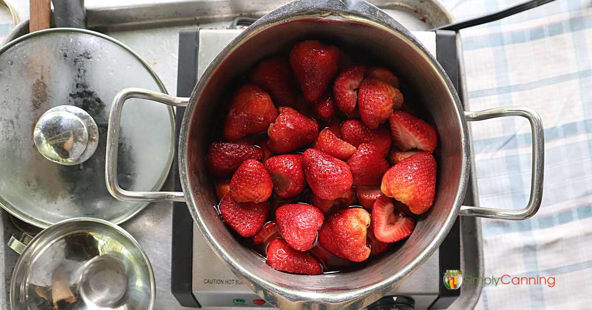 Top down view of a pot of strawberries ready to be cooked. 