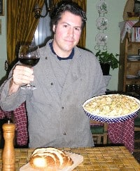 A picture of Frank with his pasta and wine.