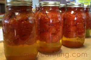 Tomato solids floating on top of tomato liquid in the jars.