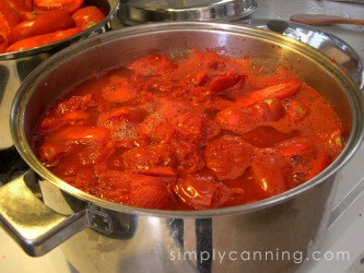 Simmering tomatoes down in a stockpot before canning.