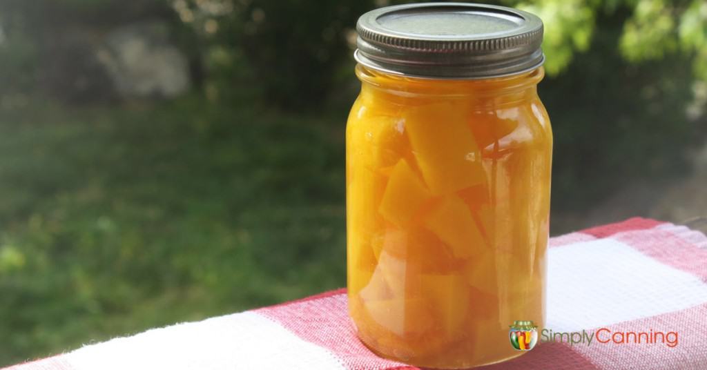 A jar of bright home canned pumpkin or squash cubes.