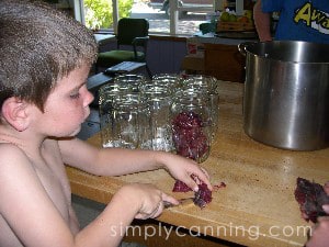 Sharon's son helping cut venison into smaller pieces for canning.