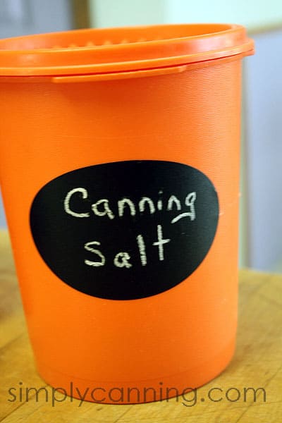 Canning salt written on a Chalky Talky label on an orange canister.