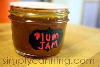 A jar of plum jam labeled with a Chalky Talky label.