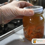 Tightening a ring on a jar of chicken soup.