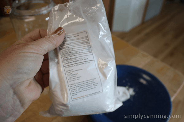 Sharon holding a package of powdery white Clear Jel over a bowl.