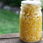 A pint jar of golden sweet corn kernels.