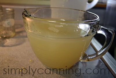 Cloudy corn cob liquid in a large glass measuring cup.