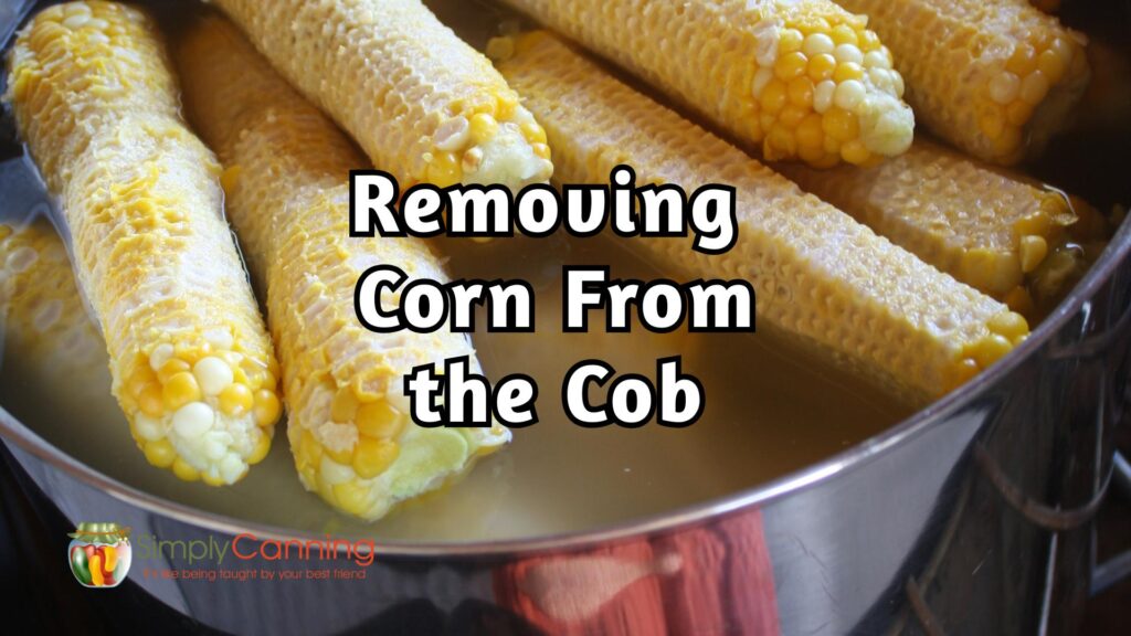 Close up of empty corn cobs in a stock pot, titled removing corn from the cob.