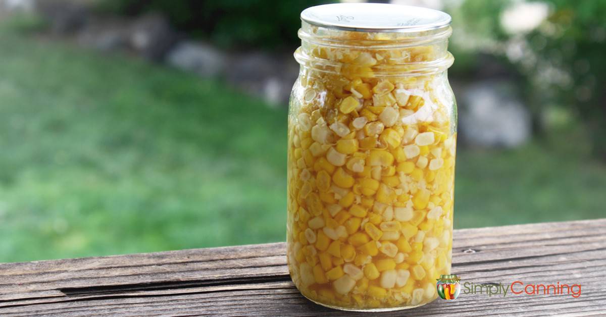 A pint jar of golden sweet corn kernels.