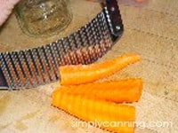 Slicing carrots using a crinkle cutter to make ruffled edges.