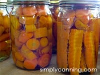Jars filled with home canned carrots.