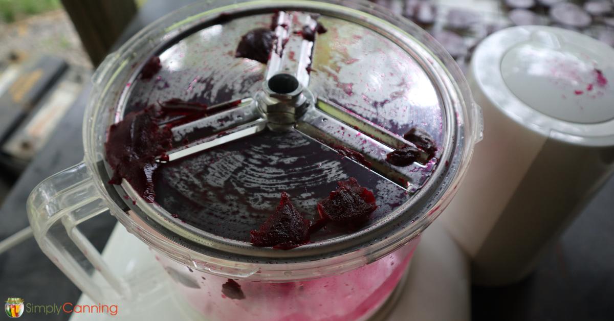 Using a food processor to slice beets into even pieces.