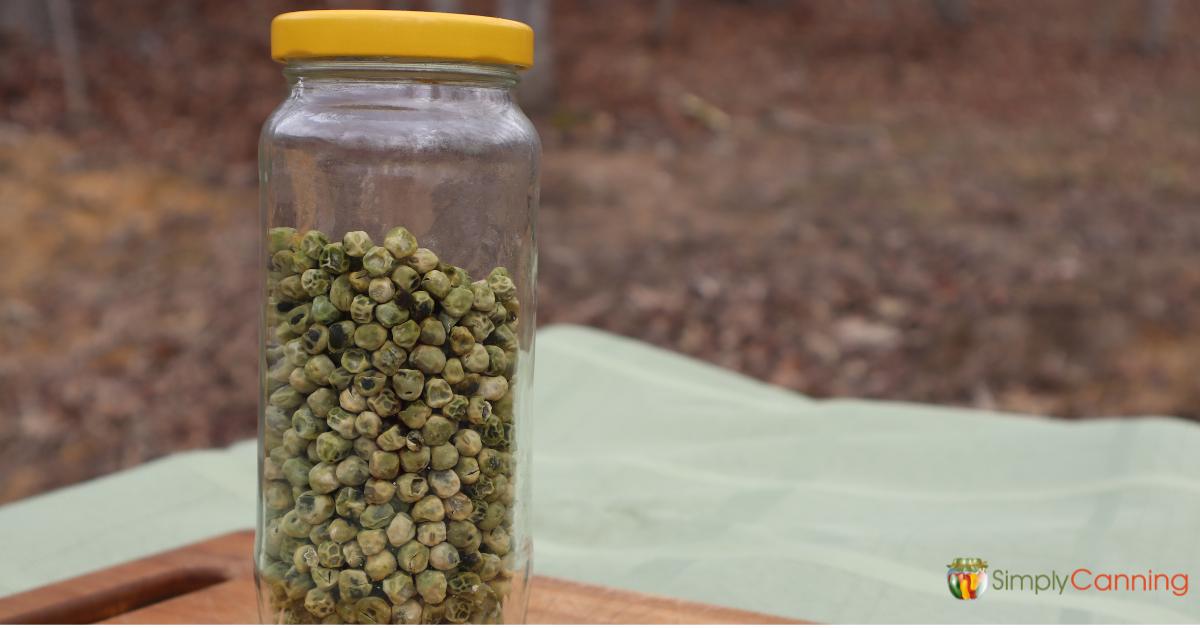 A glass jar filled with dried peas.