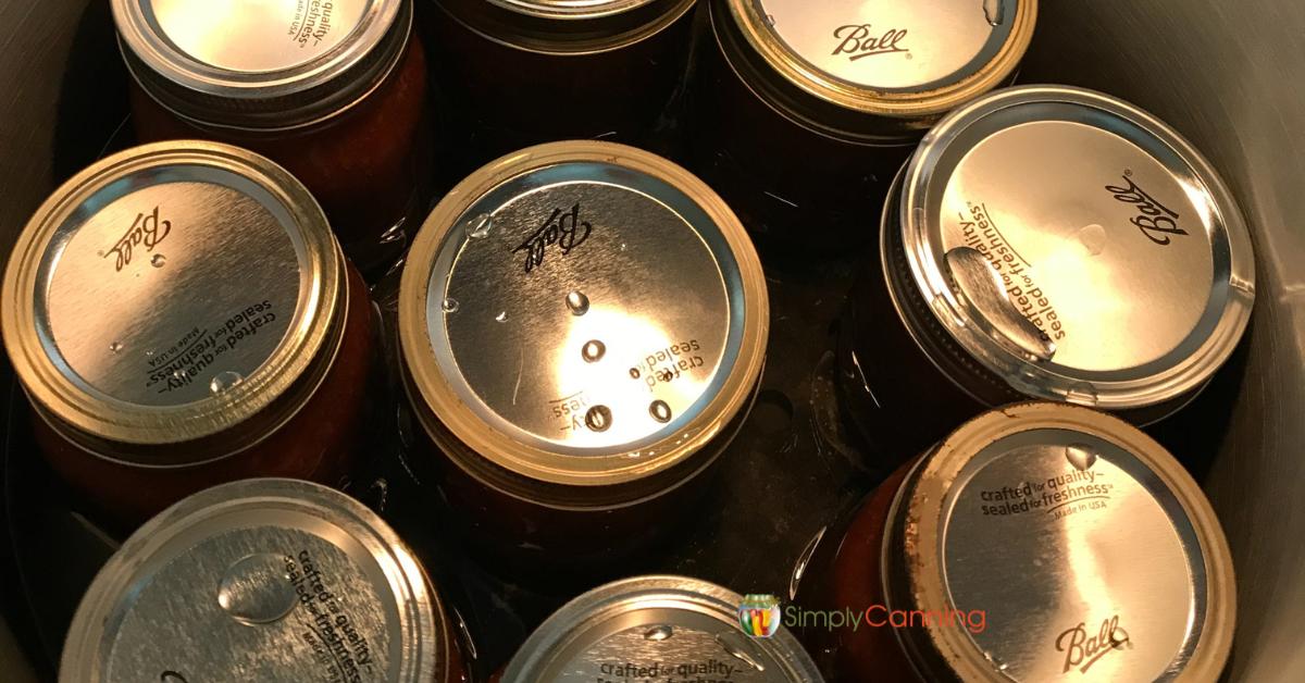 Top down close up of canning jars in a pressure canner.