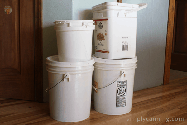 Round and square buckets of various sizes with lids.