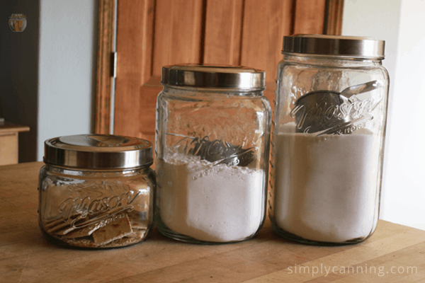 Clear glass canisters filled with dry goods.