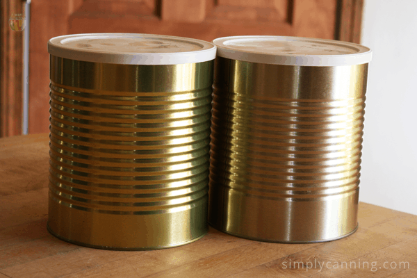 Metal cans with plastic lids on top.