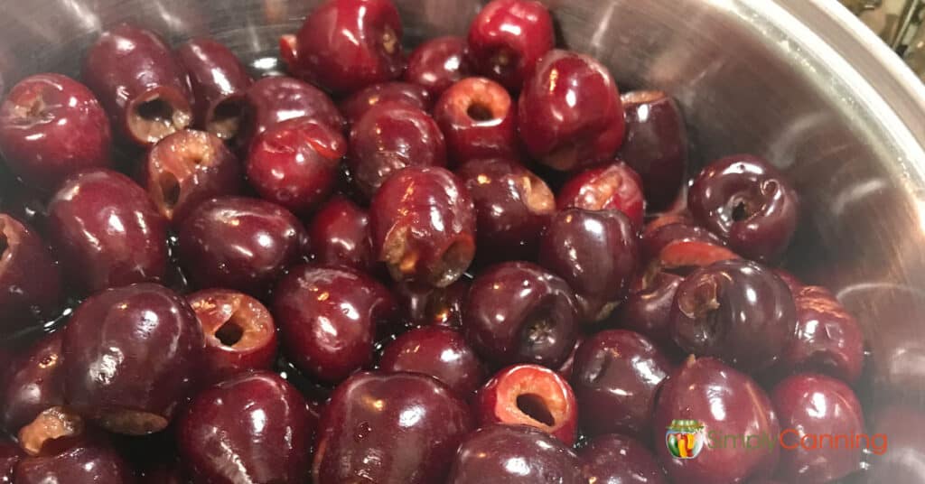 Freshly pitted cherries in a bowl.