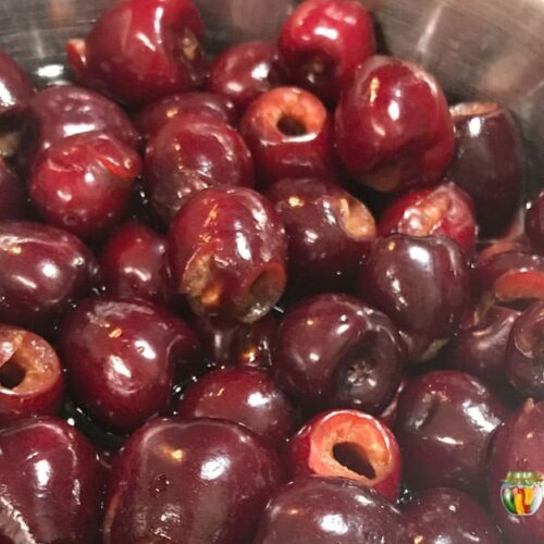Freshly pitted cherries in a bowl.