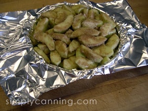 Apple mixture poured into foil lined pie plate.