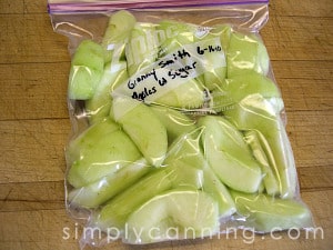 A labeled freezer bag packed with peeled and sliced apples.