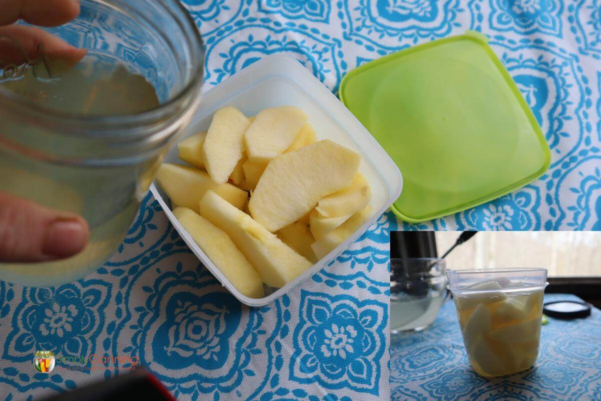 Apple slices being packed in syrup in a square freezer container with a green lid.