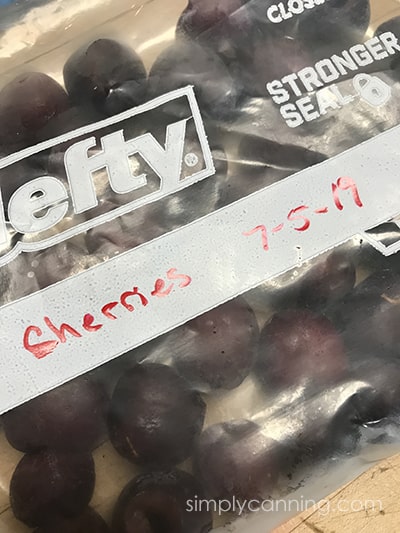 A labeled freezer bag of frozen cherries.