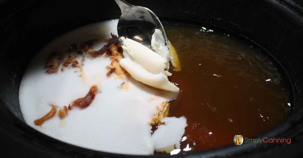 A layer of solidified fat on top of ham broth.