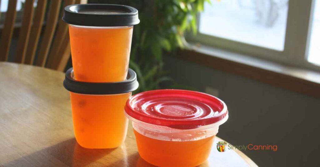 Freezer containers filled with golden ham broth