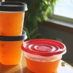 Freezer containers filled with golden ham broth