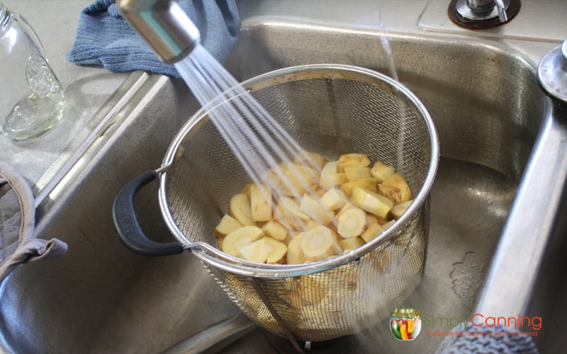 Rinsing parsnips after blanching.