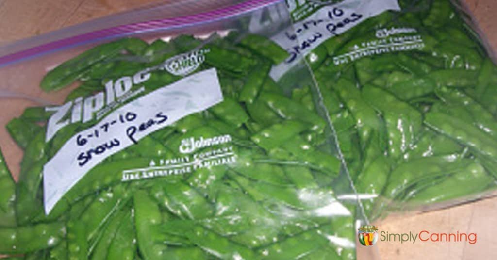 Snow peas packed into freezer bags and labeled with the contents and date.