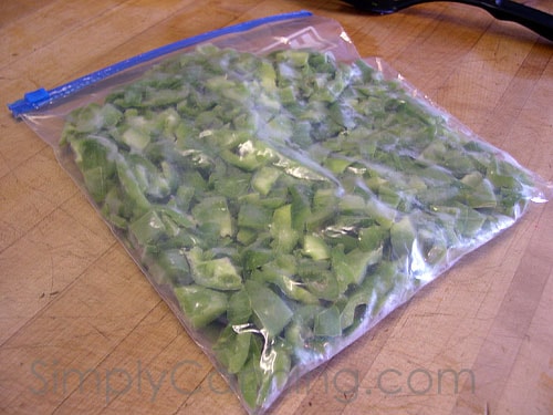 A bag packed with frozen pieces of green pepper.