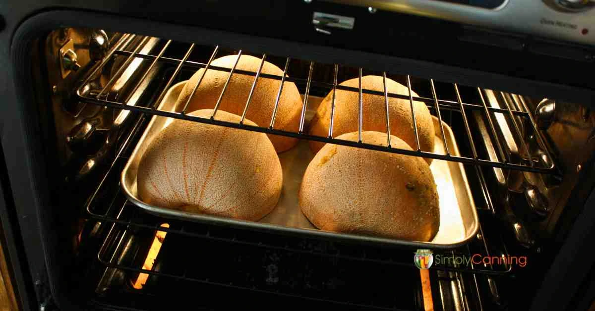 Two pumpkins halved and baking in the oven.]