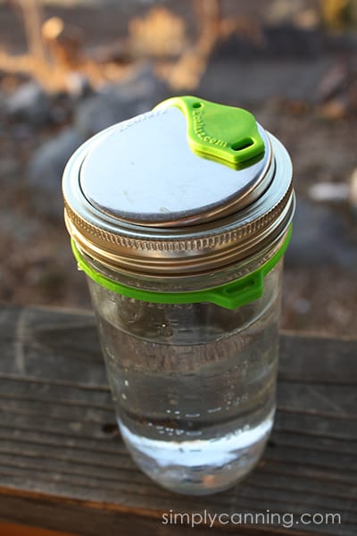 Ecojarz lid on top of a canning jar filled with water.