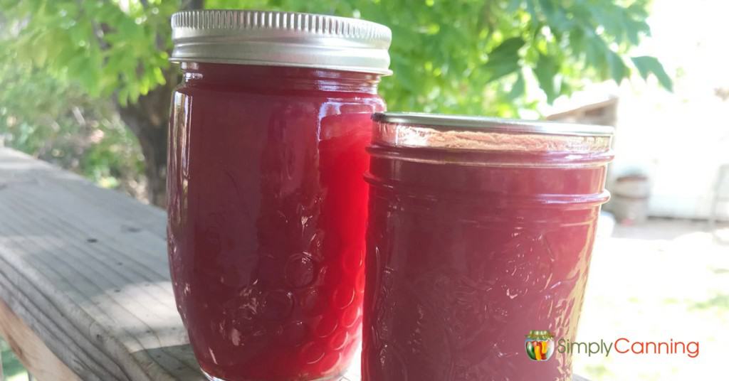 Two jars of lovely red grape jam.