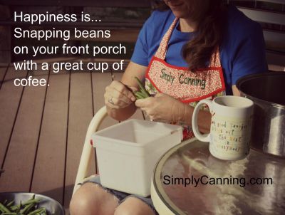 Sharon snapping beans on the porch with a cup of coffee next to her.