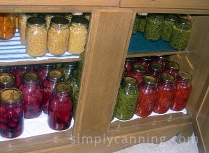 Jars of home canned vegetables in the cabinet.