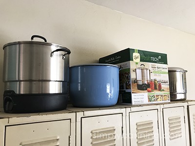 Ball Electric Water Bath Canner and other large objects sitting on top of the cabinets.