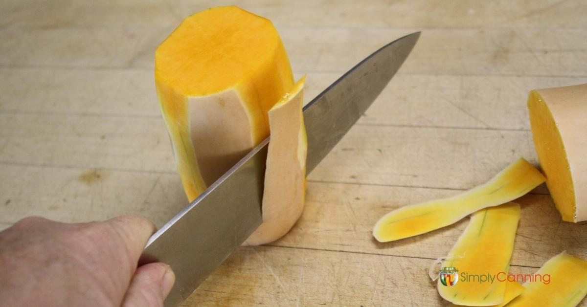 Showing how to use a large knife to peel the a butternut squash.