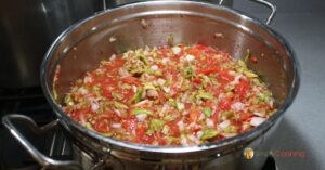 Pot of salsa on the stove.