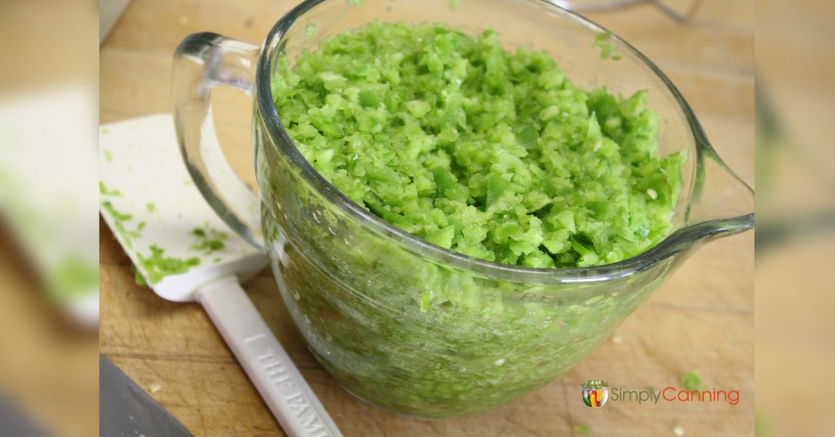 Clear mixing bowl full of chopped peppers. 