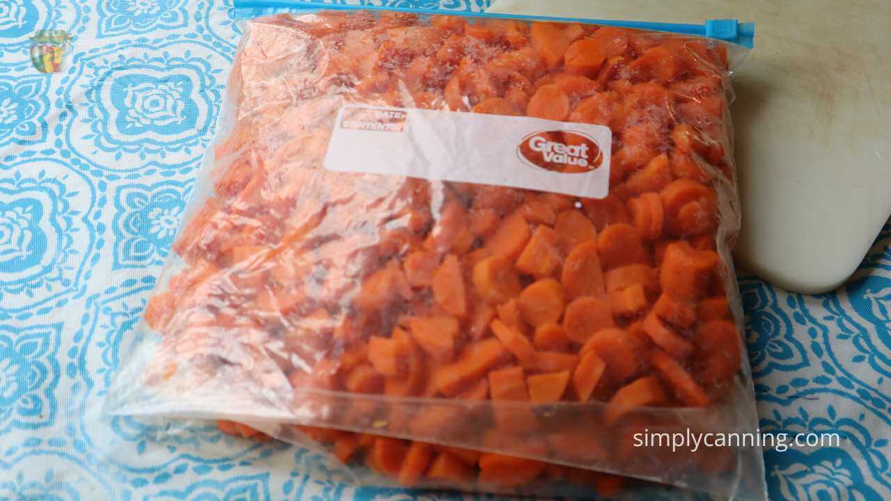 Gallon sized freezer bag filled with frozen chopped carrots. 
