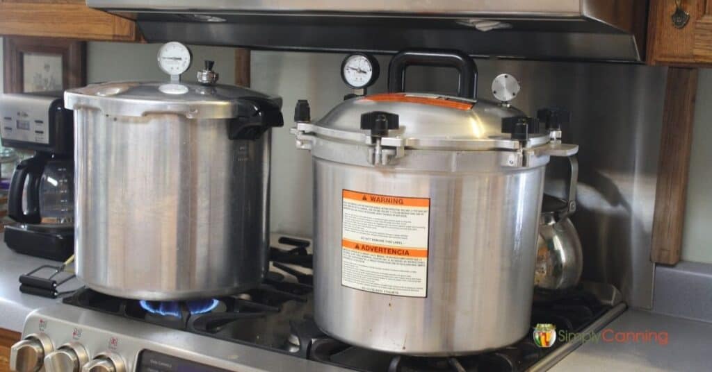 Presto and All American pressure canners sitting on the stove.